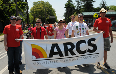 The ARCS team carries our banner through New Paltz at the 2009 Pride March.