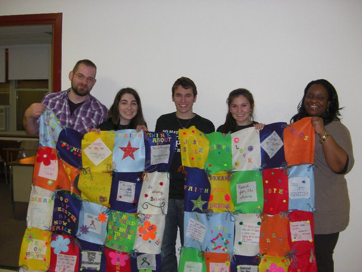 St. Thomas Aquinas Quilt L-R: J.R. Cehonski of C.A.N.D.L.E., members of Alpha Phi Omega, and LaShonda DeCosta of ARCS.
