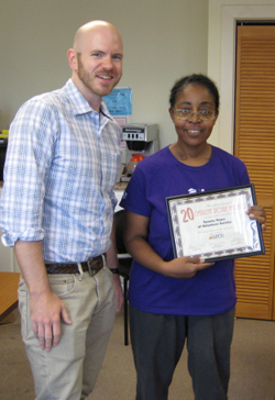 roxie_j_certificate J. Dewey, our Director of Public Relations, presents Roxie with a certificate in honor of her 20 years of volunteer service.