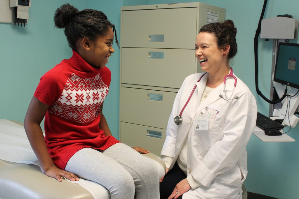 A Cornerstone medical staff member with a young patient.